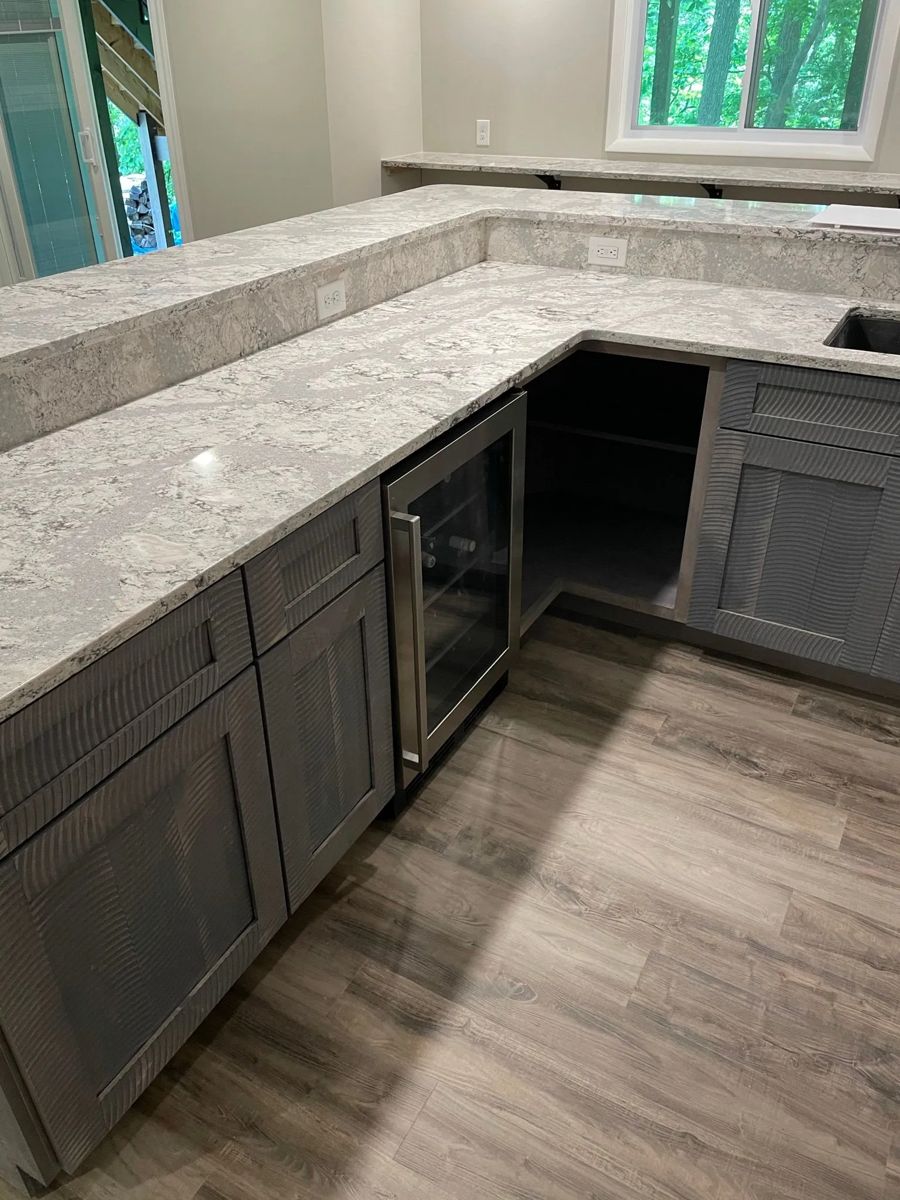 Gray cabinetry with marble counters